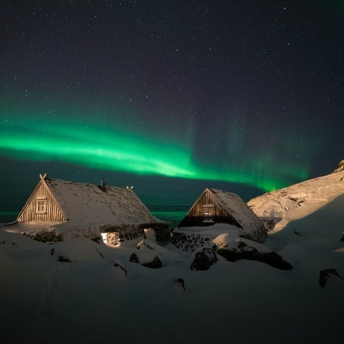 Ósvör, maritime museum in Bolungarvík bathed in the Northern lights